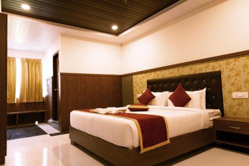 a bedroom with a large bed in a room at HOTEL GRAND ORCHID in Tirupati