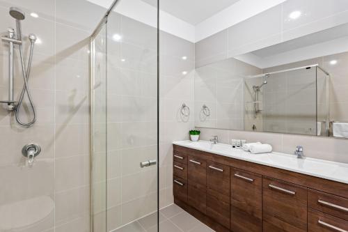 a bathroom with a glass shower and a sink at 3-Bed Beach Haven with Patio, BBQ & Secure Parking in Scarborough