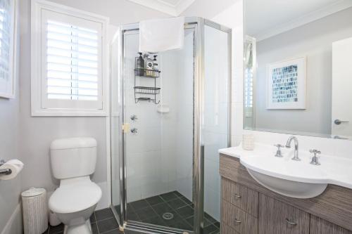 a bathroom with a shower and a toilet and a sink at Bluewater Jervis Bay - Pet Friendly with Spa in Callala Beach