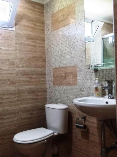a bathroom with a toilet and a sink at Villa Detelina Balchik in Balchik