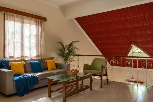 a living room with a couch and a table at Beachside Bliss Villas Candolim 10 min walk from Sinquerim Beach in Sinquerim