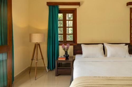 a bedroom with two beds and a window at Beachside Bliss Villas Candolim 10 min walk from Sinquerim Beach in Sinquerim