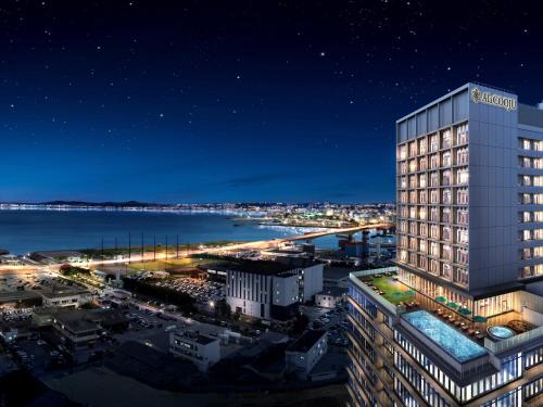 a rendering of a tall building at night at HOTEL AlaCOOJU OKINAWA in Urasoe