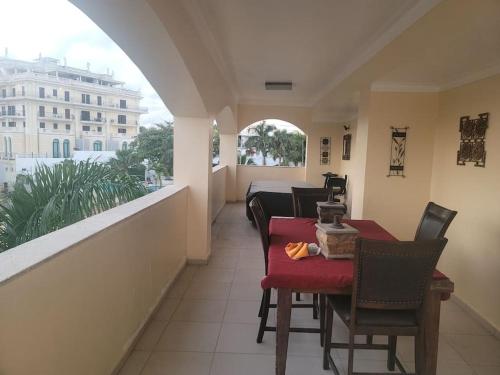a room with a balcony with a table and chairs at Ocean View Penthouse in Boca Chica