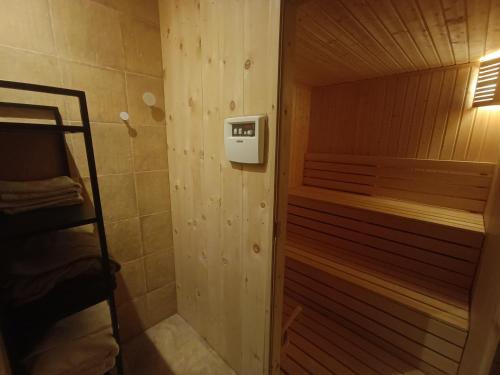 a small bathroom with a shower and a bed at Villa "Forest way" in Pirdop