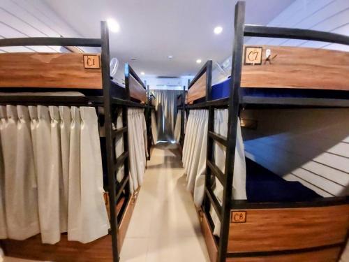 a row of bunk beds in a room at Back Home Backpackers in Bangkok