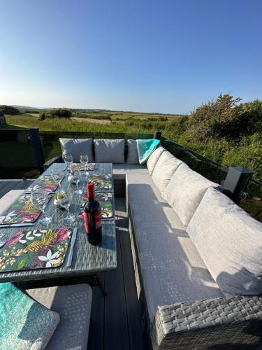 a table with a drink on top of a couch at C-Scape Lodge in Newquay