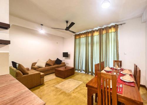 a living room with a couch and a table at Kerawalapitiya Resort in Mahabage