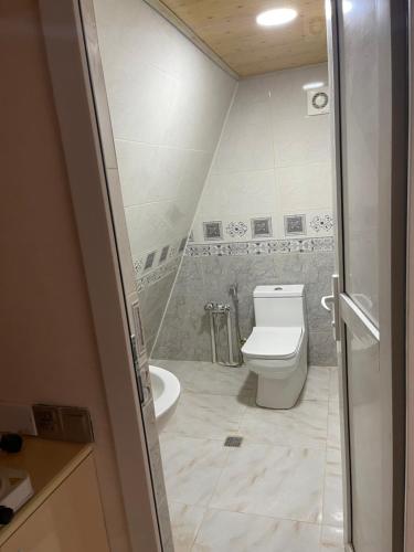 a bathroom with a toilet and a bath tub at A.frame.ev.naxcivan in Naxçıvan