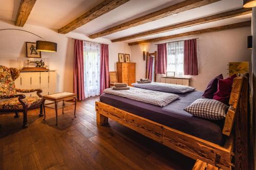 a bedroom with two beds and a chair at Beautiful cosy House near Königsee in Schönau am Königssee