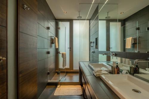 a bathroom with two sinks and a mirror at Aster by Hireavilla - 3BR w Private pool in Parra in Parra