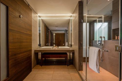 a bathroom with a sink and a mirror at Aster by Hireavilla - 3BR w Private pool in Parra in Parra
