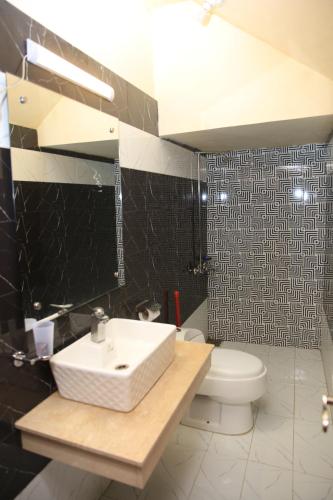 a bathroom with a sink and a toilet at Orbit Residency F-7 in Islamabad