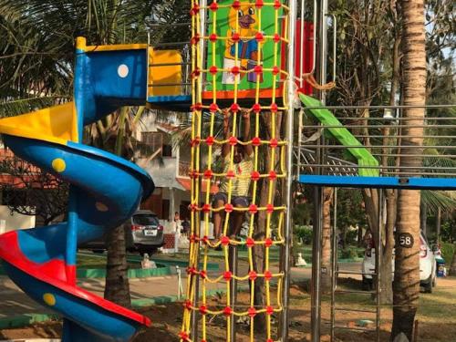a playground with a slide in a park at Sea Breeze Beach Resort in Mahabalipuram