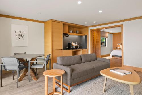 a living room with a couch and a table at SA Carbon Beach Suites in Malibu