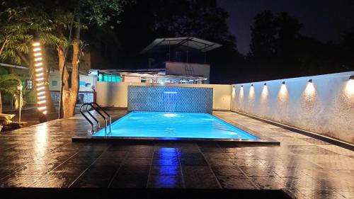 a swimming pool in a backyard at night at Kamal 2 Bedroom Bungalow With Terrace in Kīhīm