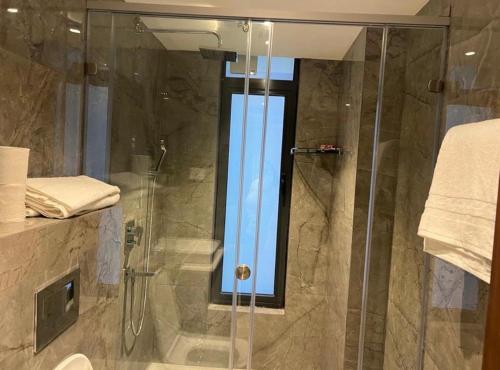 a shower with a glass door in a bathroom at Executive One Bedroom Suite Space Available in Accra