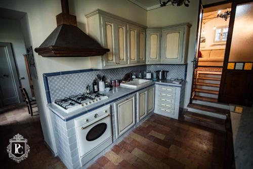 a kitchen with a stove and a sink at Palazzo Capparucci - Dimora storica in Fermo