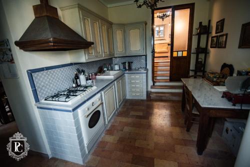 a kitchen with a stove and a sink at Palazzo Capparucci - Dimora storica in Fermo