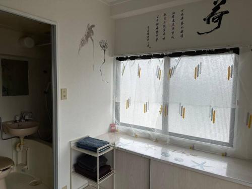 a bathroom with a window and a sink at North River701 Peace Wing 7 新サッカースタジアム近辺 in Kami-nagarekawachō