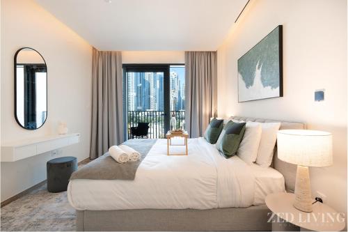 a bedroom with a large bed with a large window at Zed Living - Ahad Residences - Tranquil 1 BR in Business Bay in Dubai