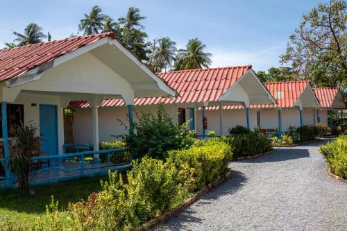 a row of houses with red roofs at Isara Lanta Beach Resort in Ko Lanta