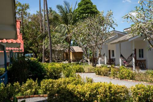 a garden in front of a house at Isara Lanta Beach Resort in Ko Lanta
