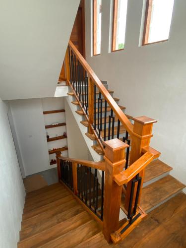 a staircase with wooden railings in a house at THE DOCTORS VILLA in Ragama