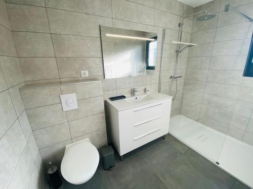 a bathroom with a toilet and a sink and a tub at "Villa Verde "au coeur de Ghisonaccia in Ghisonaccia