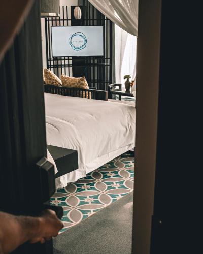 a bedroom with a bed and a television at Hotel Vellita Siem reap in Siem Reap