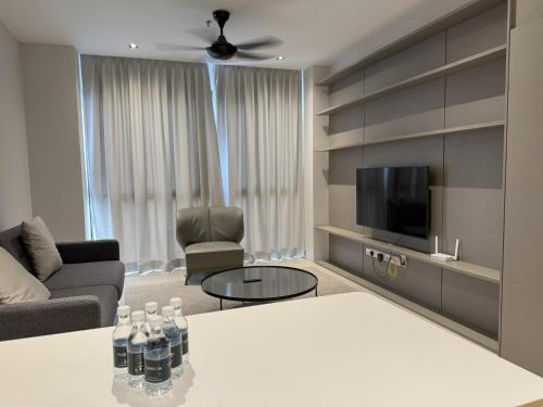 a living room with a couch and a tv at Lumi Tropicana in Petaling Jaya