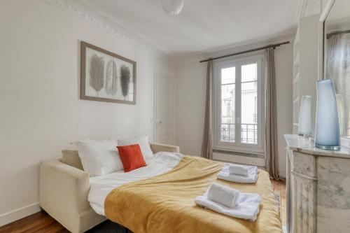 um quarto branco com uma cama e um sofá em Lovely & authentic Flat - Parc des Expos - Paris 15 em Paris