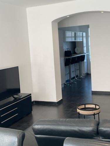 a living room with a couch and a flat screen tv at Grand appartement a 5 minutes du stade vélodrome, parking in Marseille