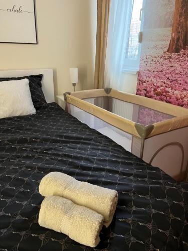 una camera da letto con un letto con due asciugamani sopra di Lumos a Sombor