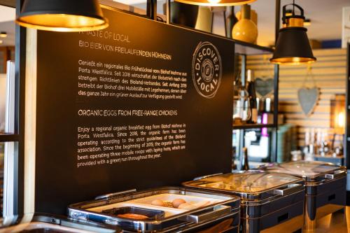 a display case in a bakery with some pastries at Mercure Hotel Bad Oeynhausen City in Bad Oeynhausen