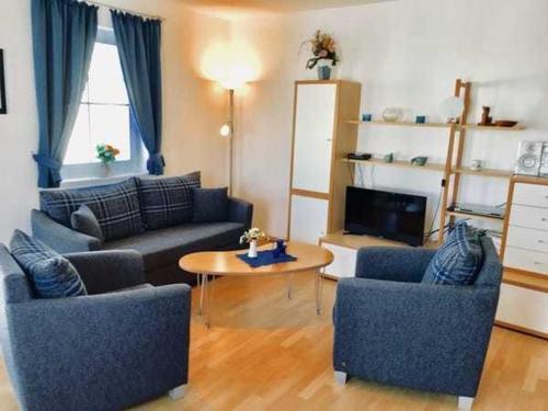 a living room with two couches and a table at Haus Volksbank FV in Binz