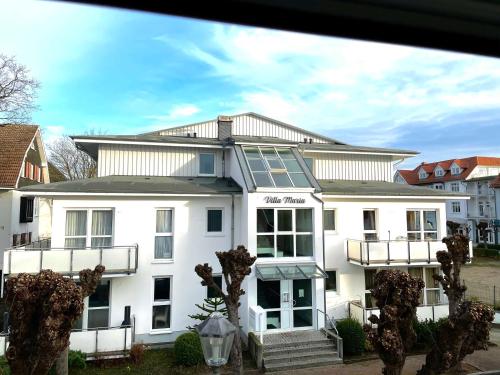 a white building with a solarium on top of it at Villa Maria 10 in Binz