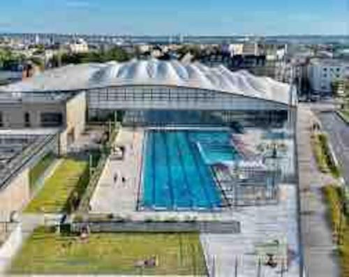 un grand bâtiment avec une piscine à l'intérieur dans l'établissement 23m2 climatisé avec Parking privé secteur Roosevelt - Arena, à Reims