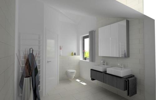 a white bathroom with two sinks and a mirror at Chalet Weibhauser in Schönau am Königssee