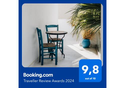 a table and chairs in a room with a plant at Zima Blue in Zygi