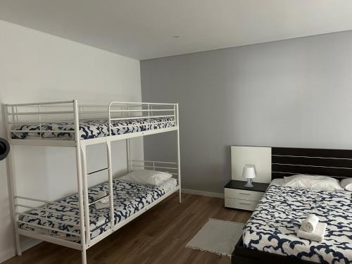 a bedroom with two bunk beds in a room at Marquês de Pombal 55 in Peniche