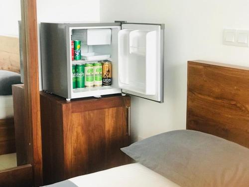an open refrigerator with drinks inside of it at Ganesh Garden Beach Cabanas in Tangalle
