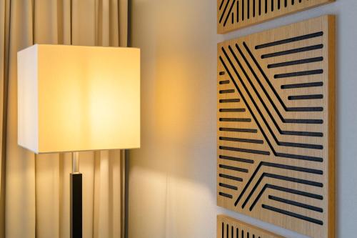 a lamp next to a keyboard on a wall at Mercure Düsseldorf Kaarst in Kaarst