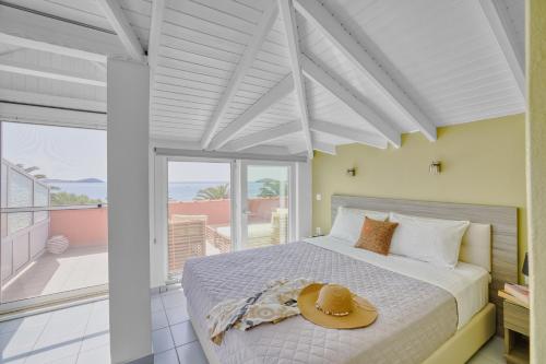 a bedroom with a bed with a hat on it at Platy Beach Hotel in Platy