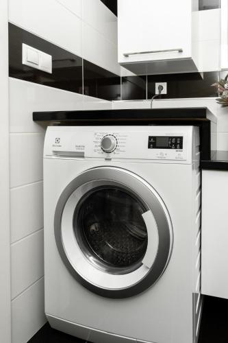 a white washer and dryer in a kitchen at BNB New Beautiful Apartment in the Center of Ostrava with option Garage Parking in Moravská Ostrava