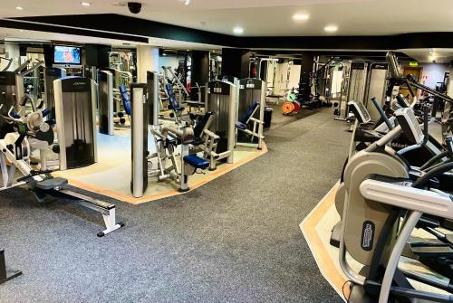 a gym with lots of treadmills and machines at Bridge House Hotel, Leisure Club & Spa in Tullamore