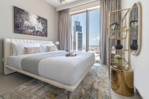 a bedroom with a large bed and a large window at Frank Porter - Forte Tower 1 in Dubai