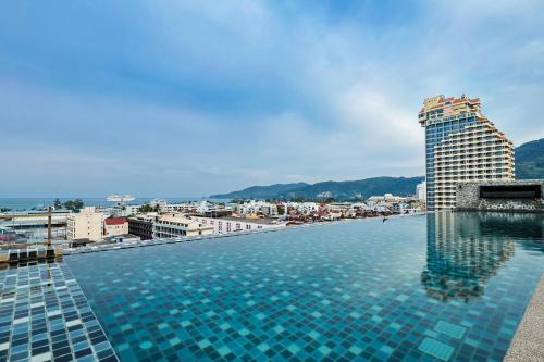 a swimming pool on top of a building at The Gig Hotel in Patong Beach