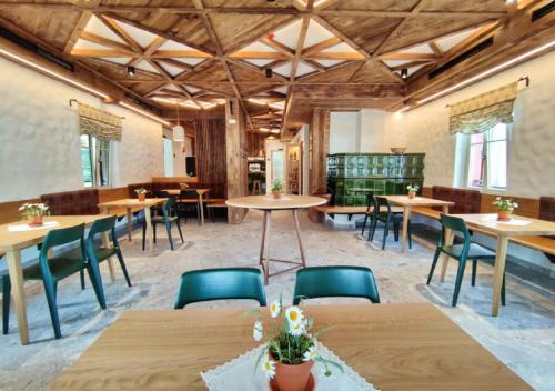 a large room with wooden tables and chairs at Guesthouse & Camping Danica Bohinj in Bohinj