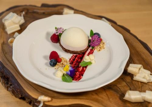 a dessert on a white plate on a table at Guesthouse & Camping Danica Bohinj in Bohinj